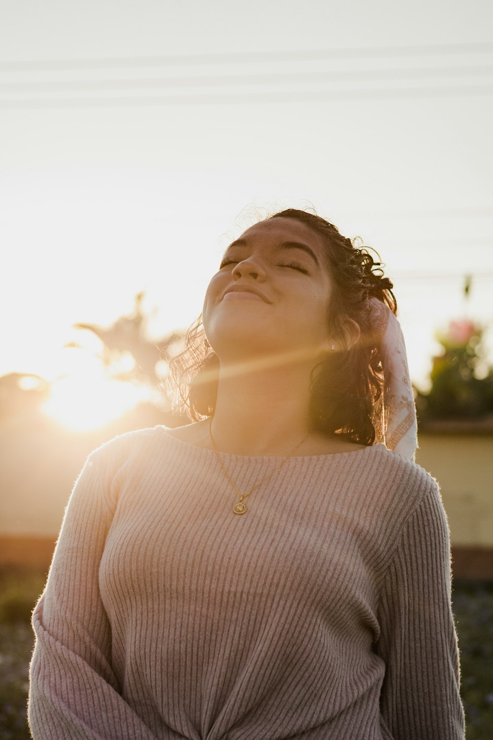 woman in gray sweater looking up