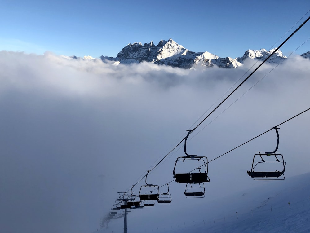 aerial photography of cable cars in a snowy mountain