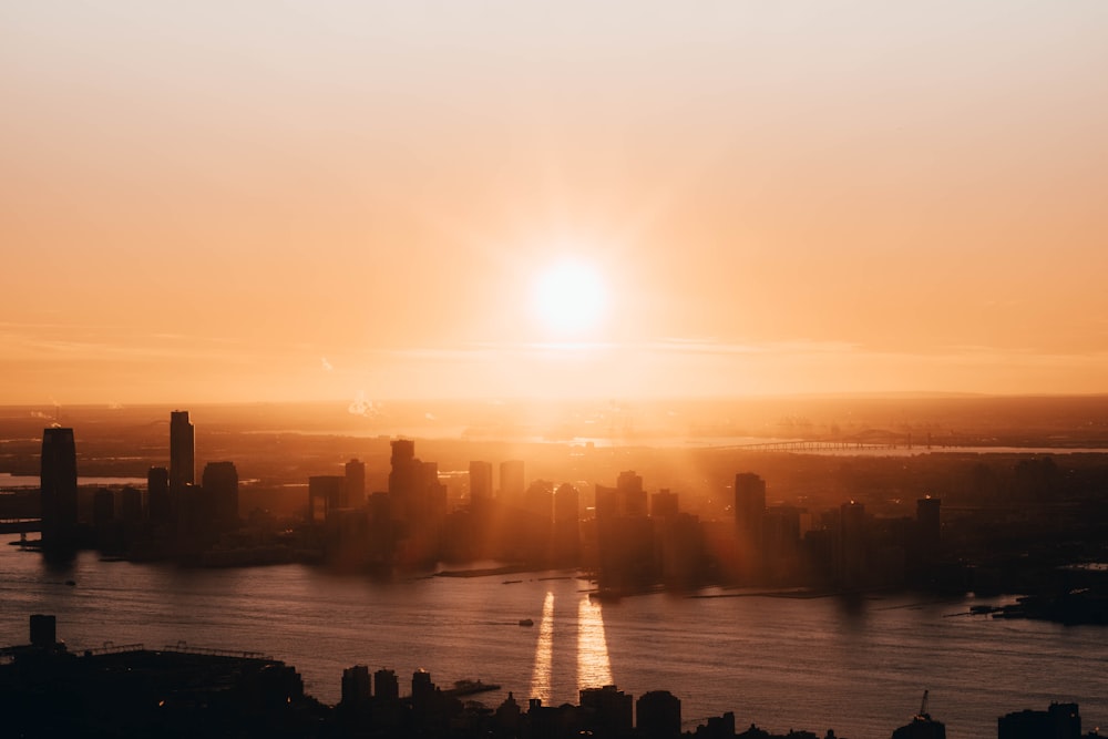 aerial photo of cityscape near river at sunset