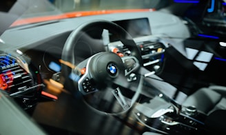 Close-up of hands on a steering wheel inside a modern car with clear dashboard controls.