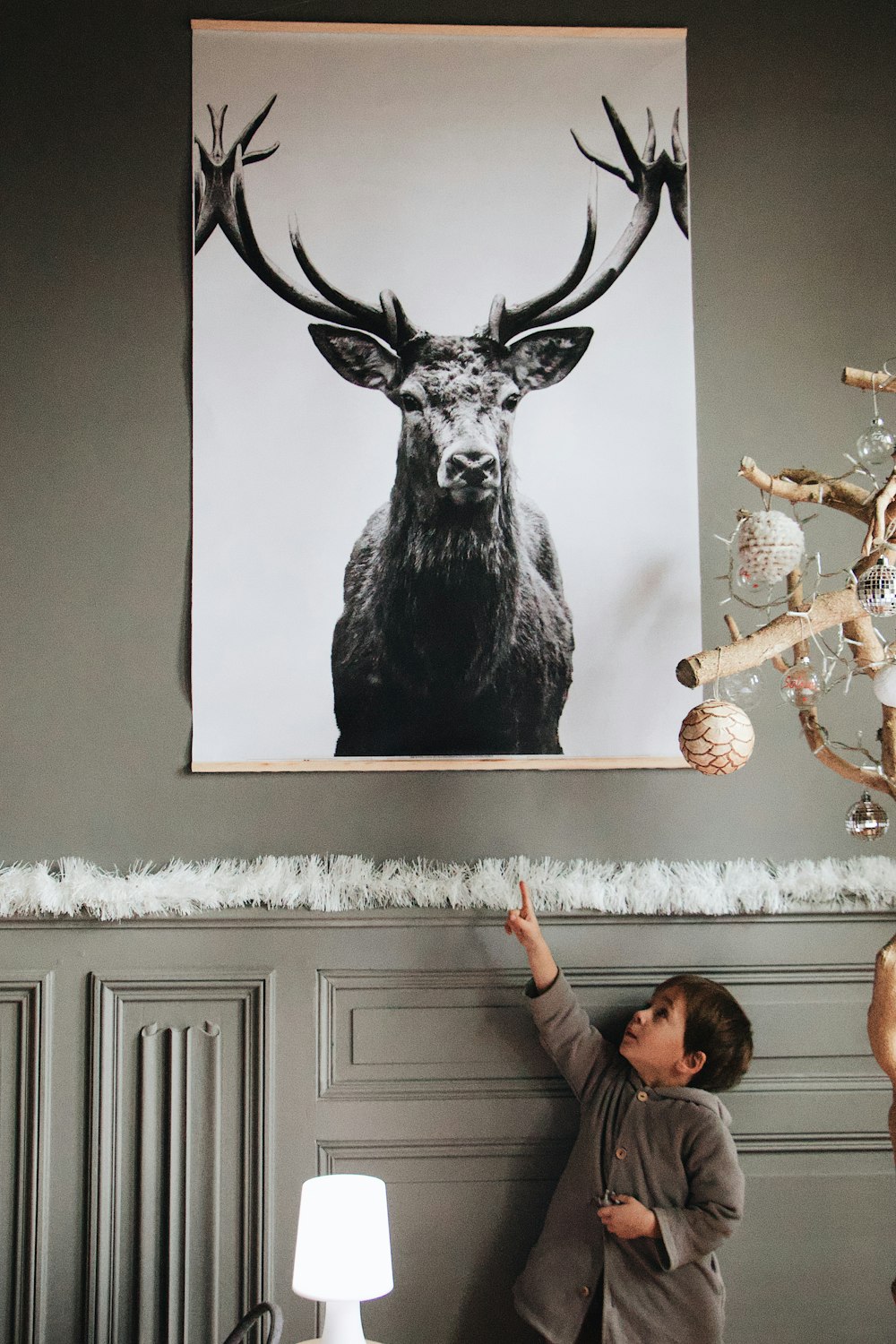 boy pointing Deer painting