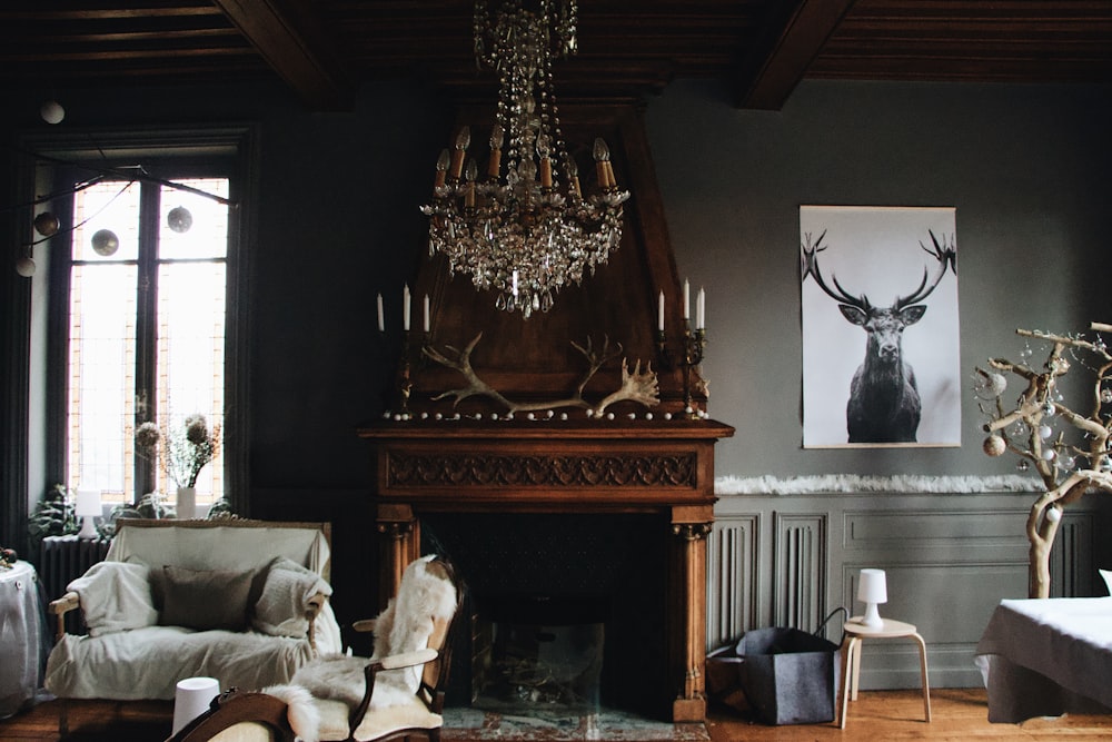 brown wooden fireplace beside a gray fabric sofa chair