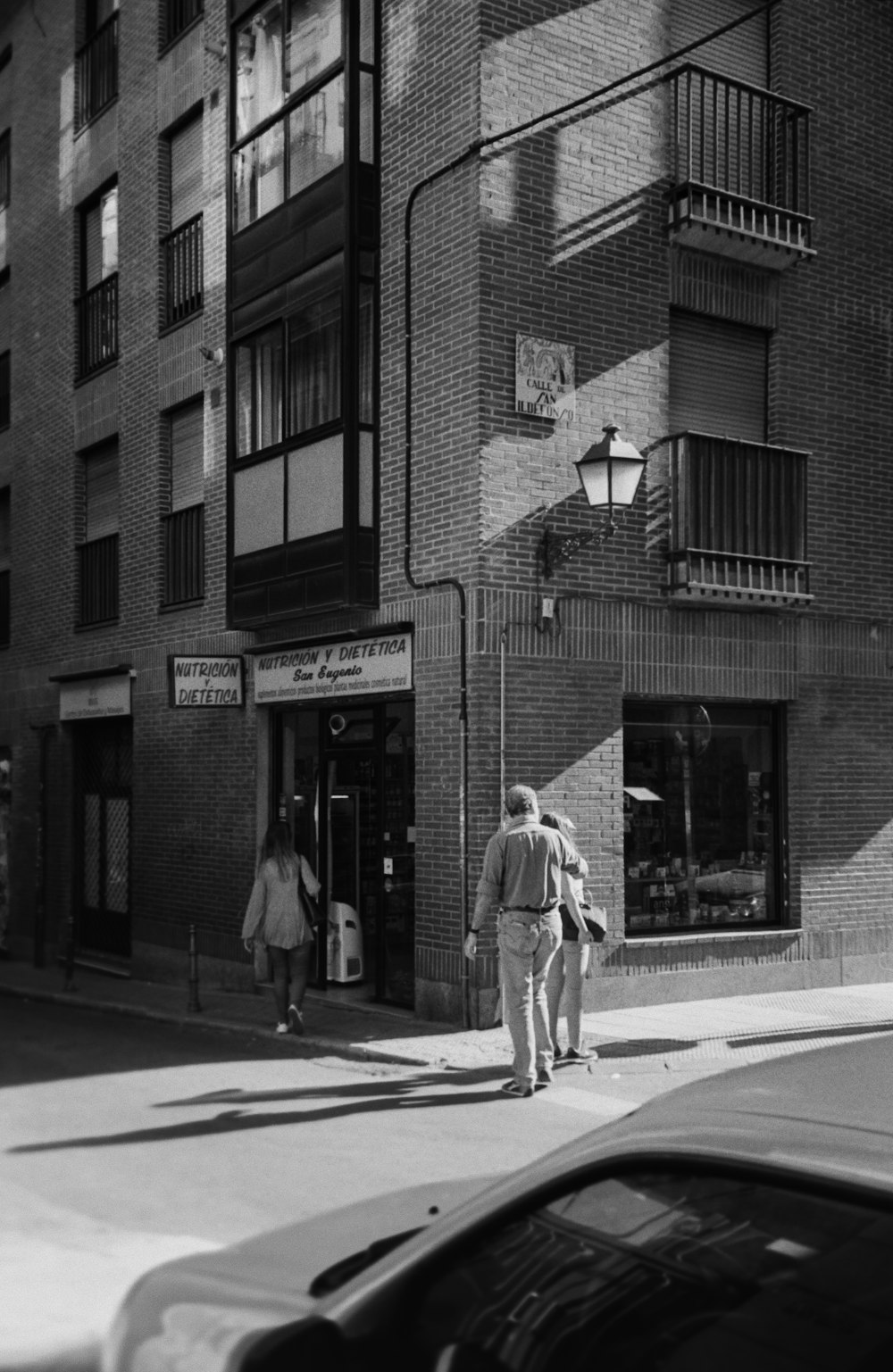 grayscale photography of person persons walking outdoors