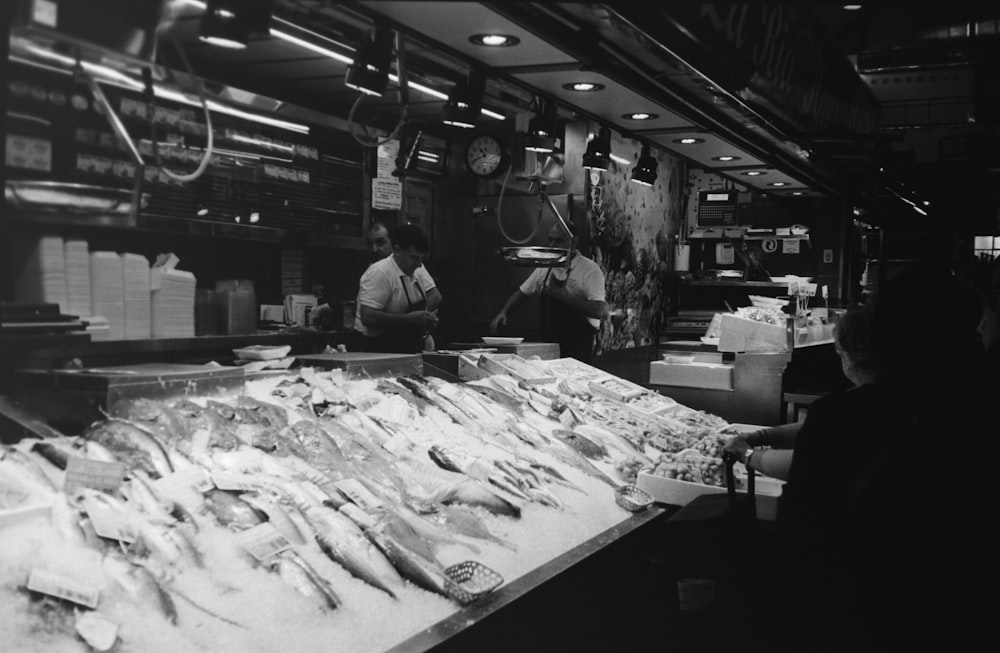 a black and white photo of a fish market