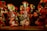 A group of performers dressed in vibrant, festive costumes with large, colorful feathered headdresses. They appear to be engaged in a traditional dance, with some playing musical instruments like drums. The scene is illuminated by stage lighting, enhancing the vividness of their attire.