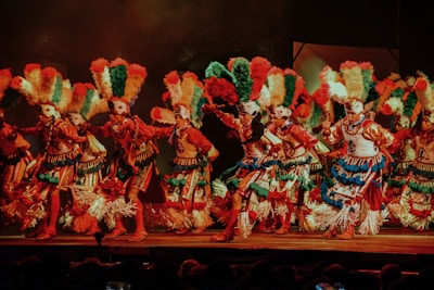 Close-up of traditional dancers in vibrant costumes performing on stage.