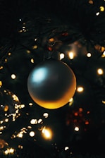 Close-up of a detailed 3D printed holiday ornament glowing softly in warm light.