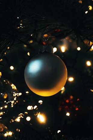 Close-up of a detailed 3D printed holiday ornament glowing softly in warm light.