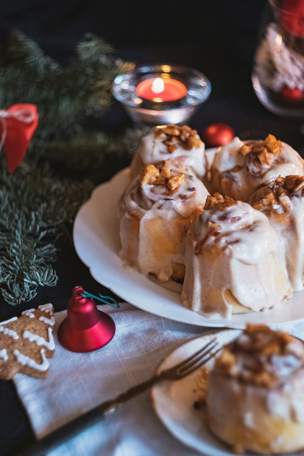 plate of cinnamon rolls beside a lighted tealight