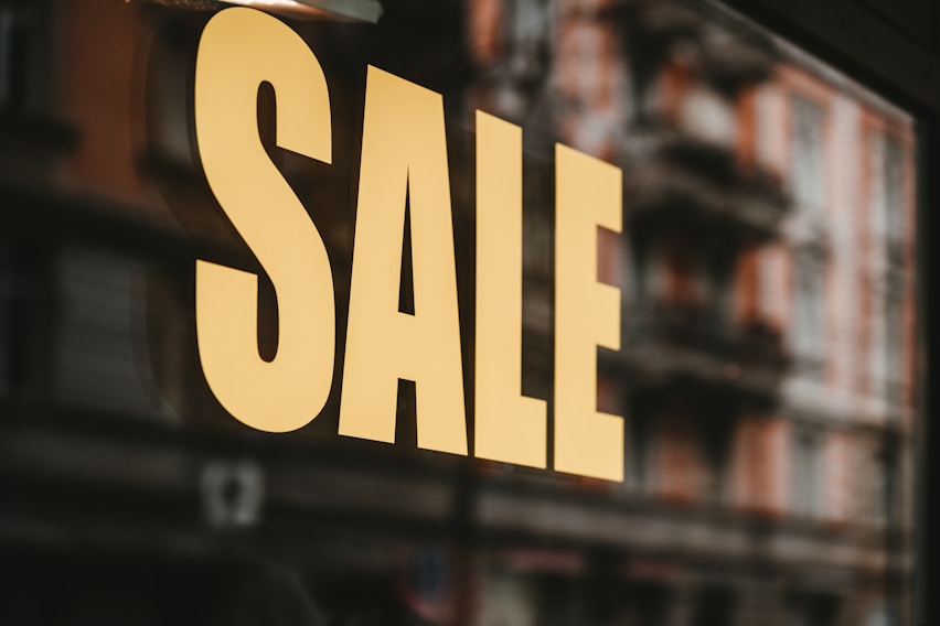 yellow sale text printed on glass window