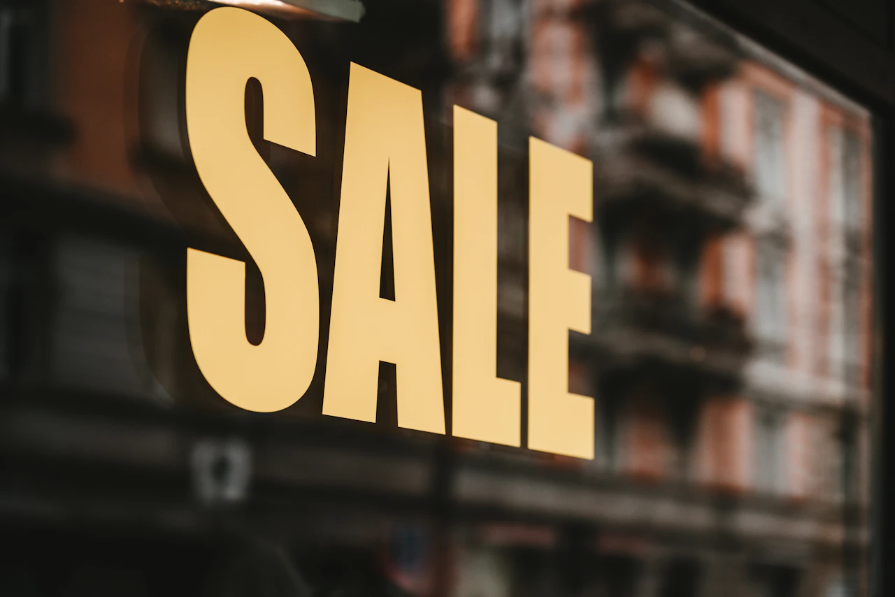 Bold SALE lettering on a storefront window, the kind of time-limited offer that needs an automatic end date