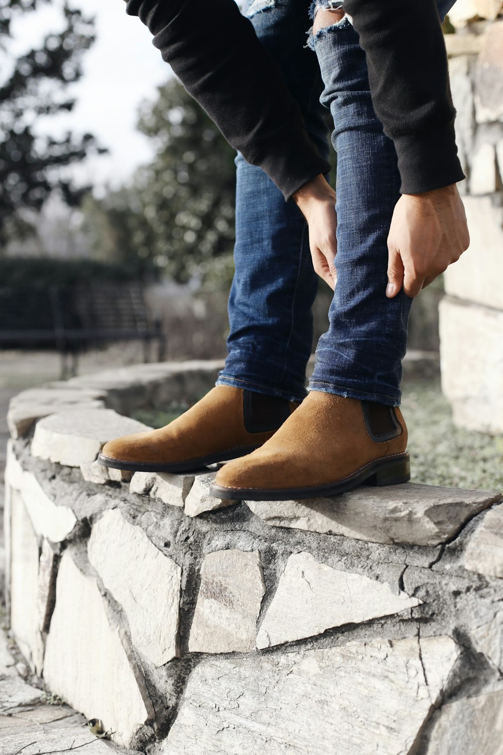 Person Wearing Blue Denim Jeans And Brown Suede Chelsea Boots Standing Photo Free Apparel Image On Unsplash