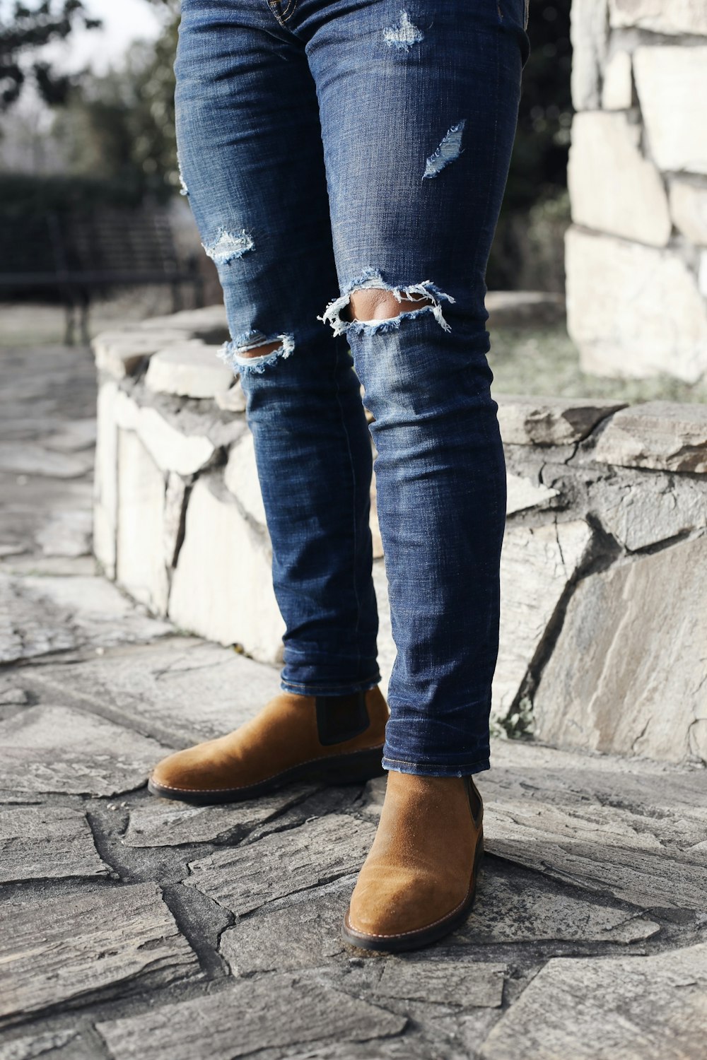 Person wearing blue denim fitted jeans and pair of brown chelsea boots  photo – Free Apparel Image on Unsplash