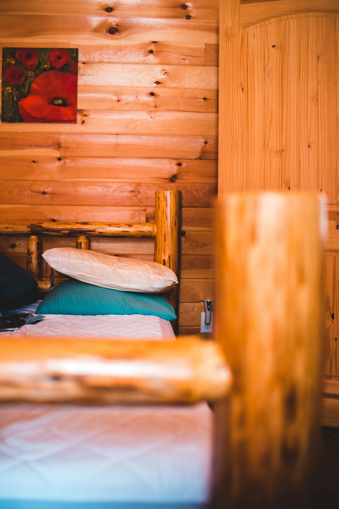 pillows on top of bed with wooden frame