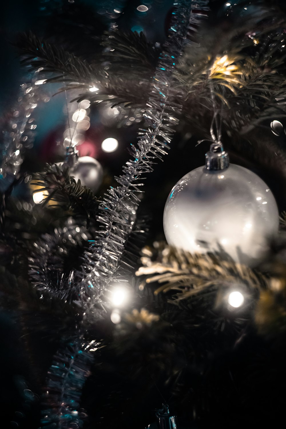 silver baubles hanging in a Christmas tree