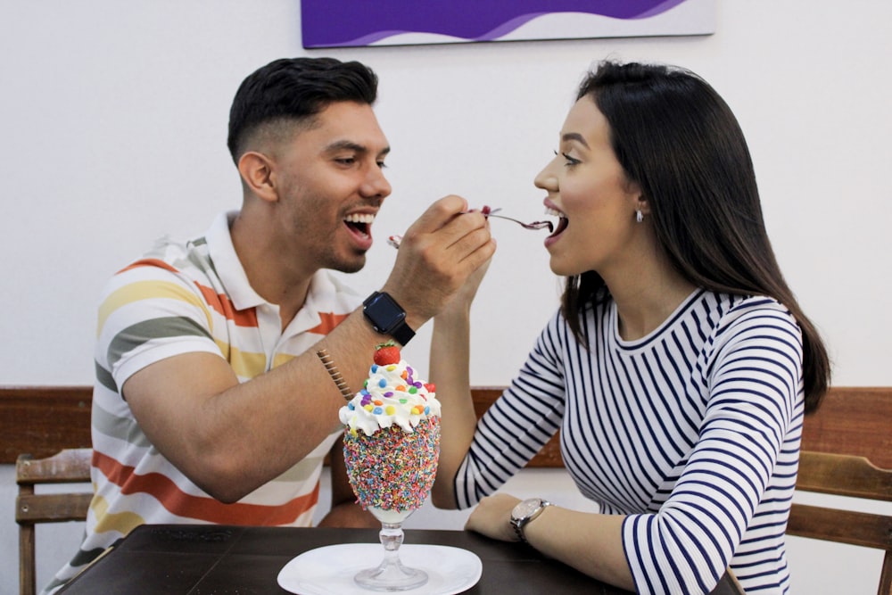 man and woman about to feed each other