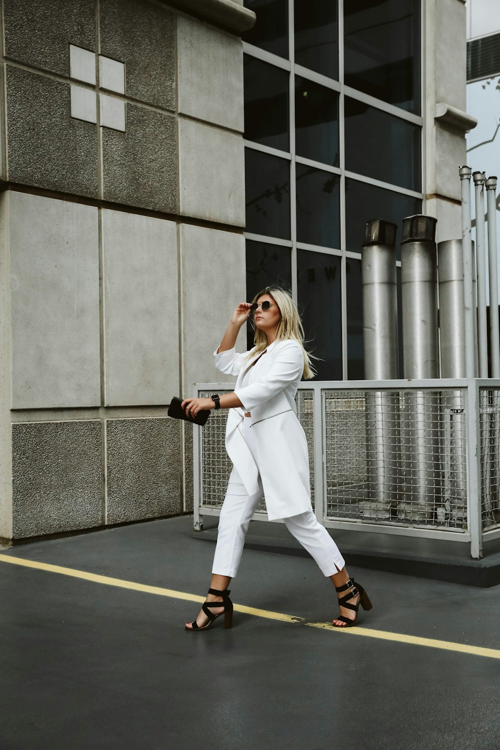 woman walking on street in front of building