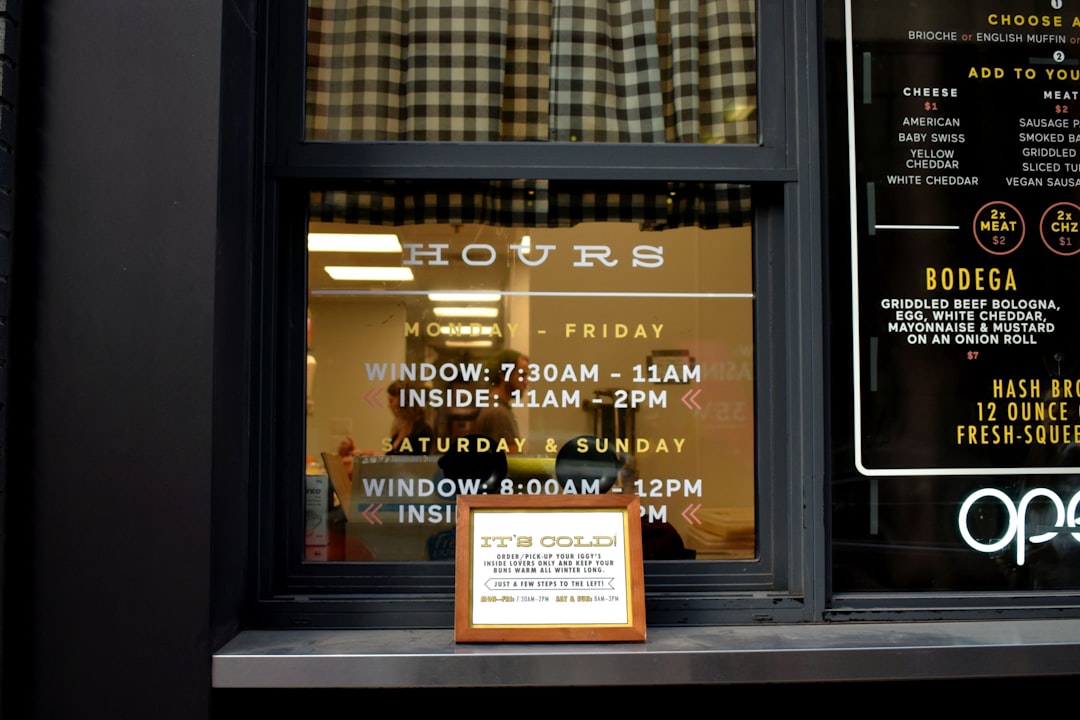 brown wooden framed certificate placed by a glass window