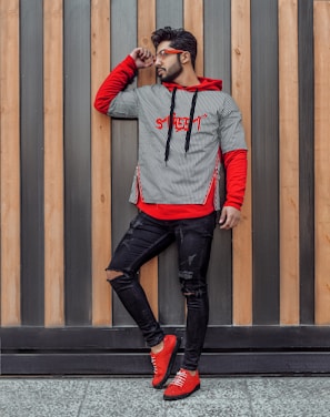 shallow focus photo of man in gray and red pullover hoodie