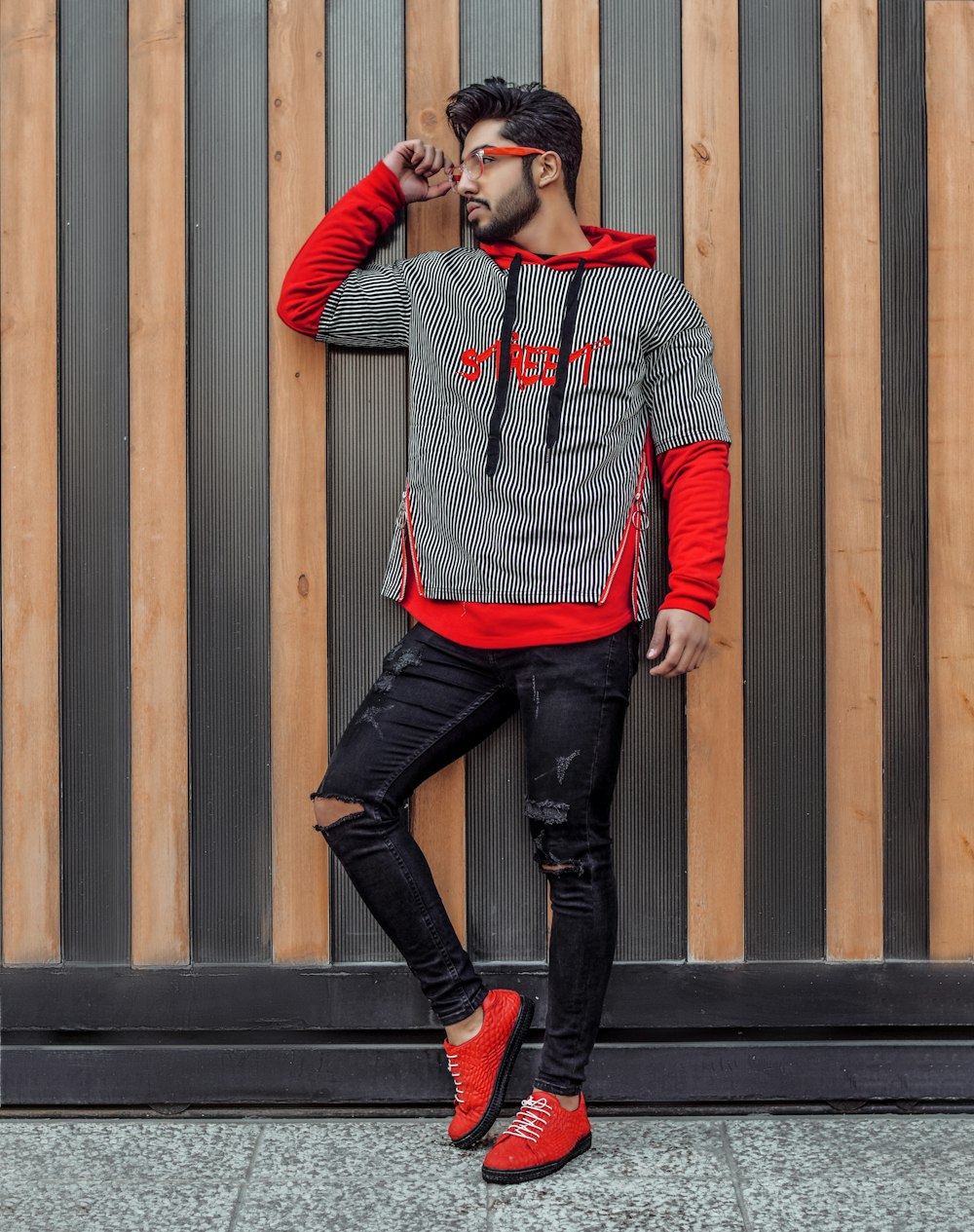 shallow focus photo of man in gray and red pullover hoodie