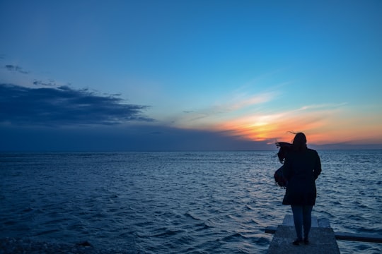 woman standing near body of water in Durrës Albania