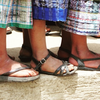 A group of individuals wearing sandstone stepwear in a vibrant urban setting.
