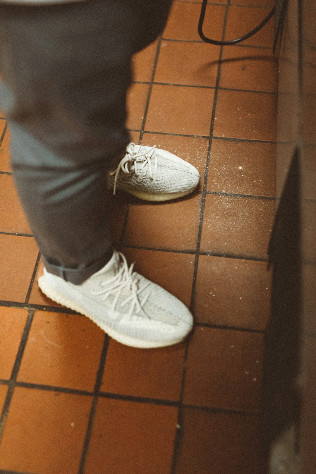 person wearing white running shoes