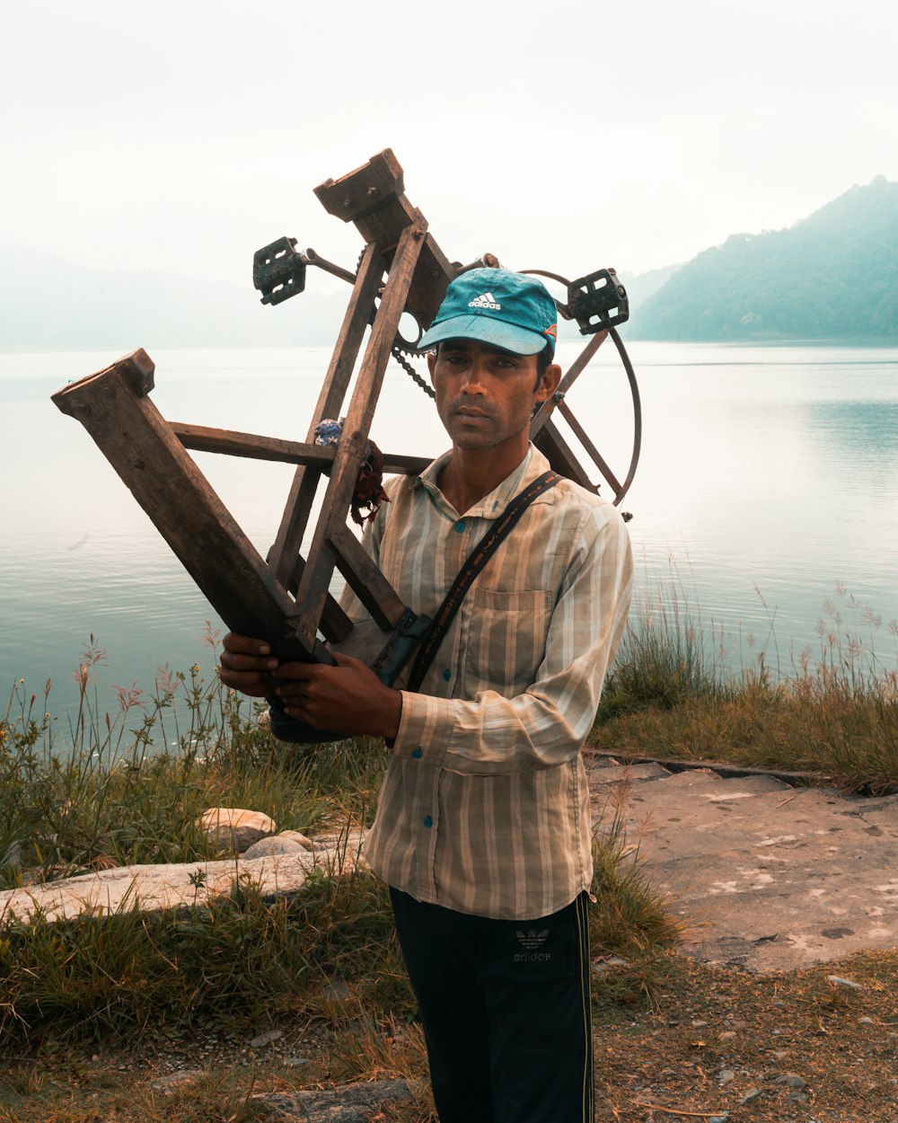 man holding wooden bike