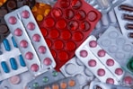 pile of blister packs of colorful medicine tablets