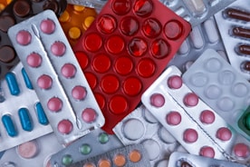 pile of blister packs of colorful medicine tablets
