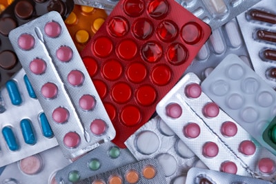 pile of blister packs of colorful medicine tablets