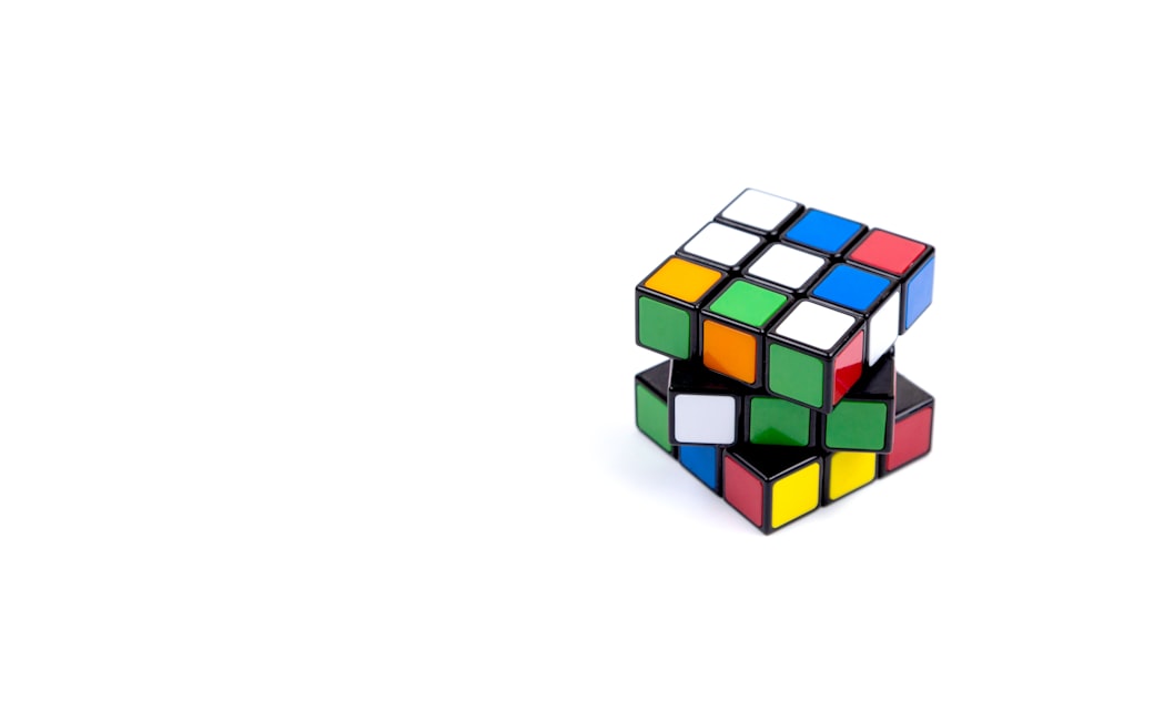 Game multi-coloured cube on a white background. Game concept with copy space for text
