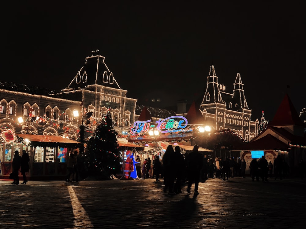 a group of people standing around a christmas market