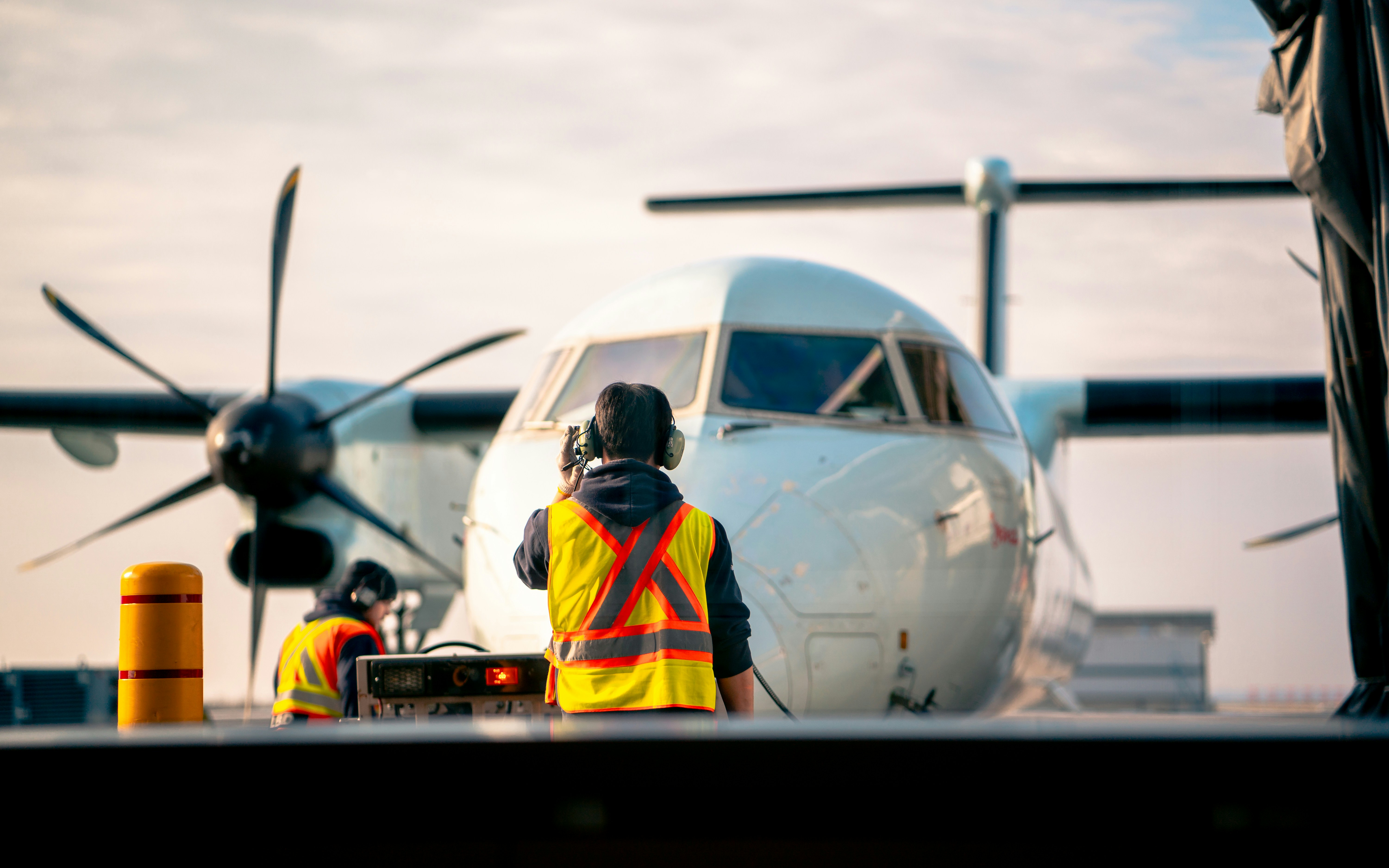 photography of man standing in front of airplane