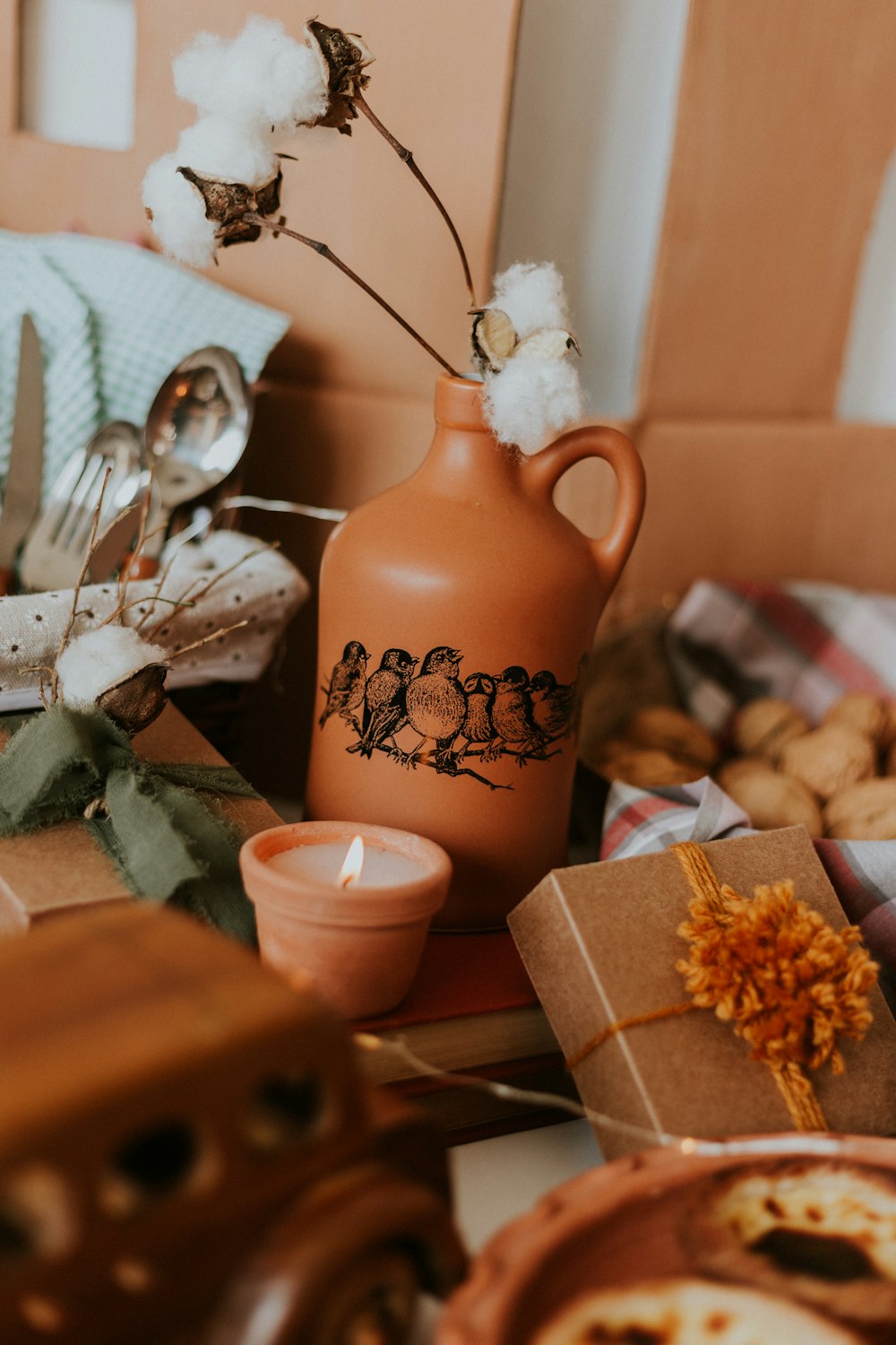 brown bottle with white cotton flowers