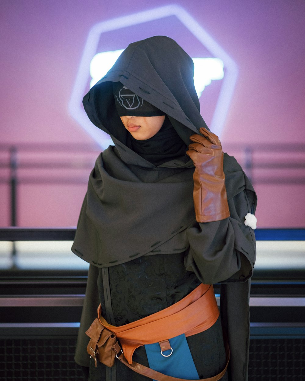 woman wearing black hijab headscarf with mask standing