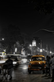 A modern taxi car parked on a city street at sunset.