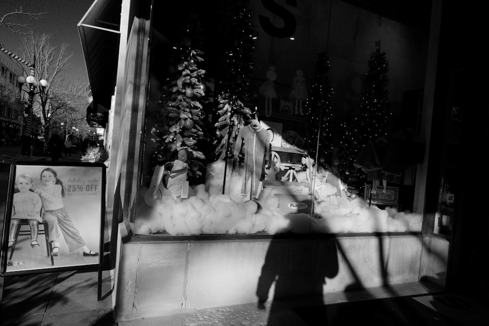 grayscale photography of Christmas tree inside store
