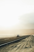 white car on gray asphalt road during daytime