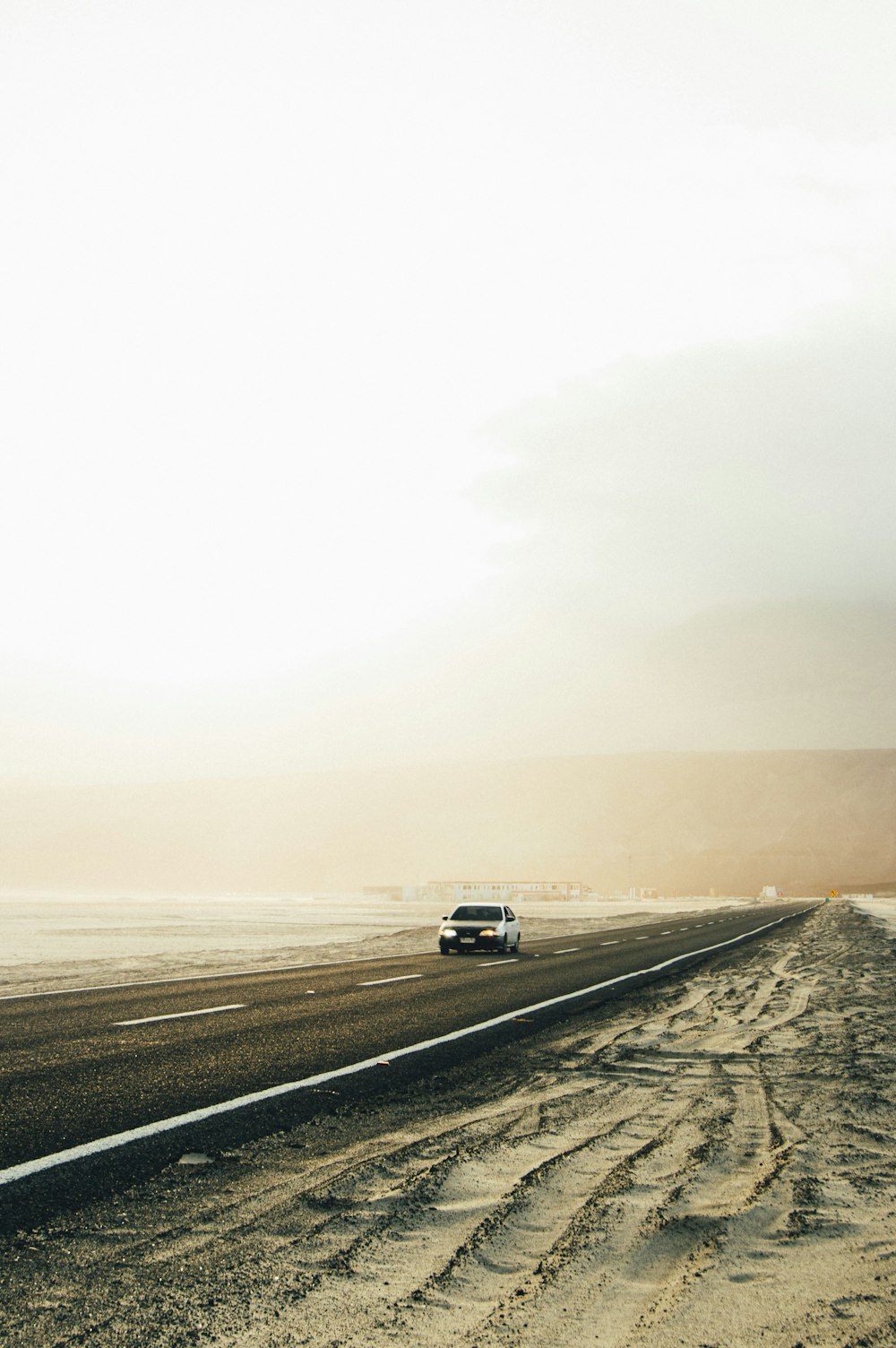 white car on gray asphalt road during daytime