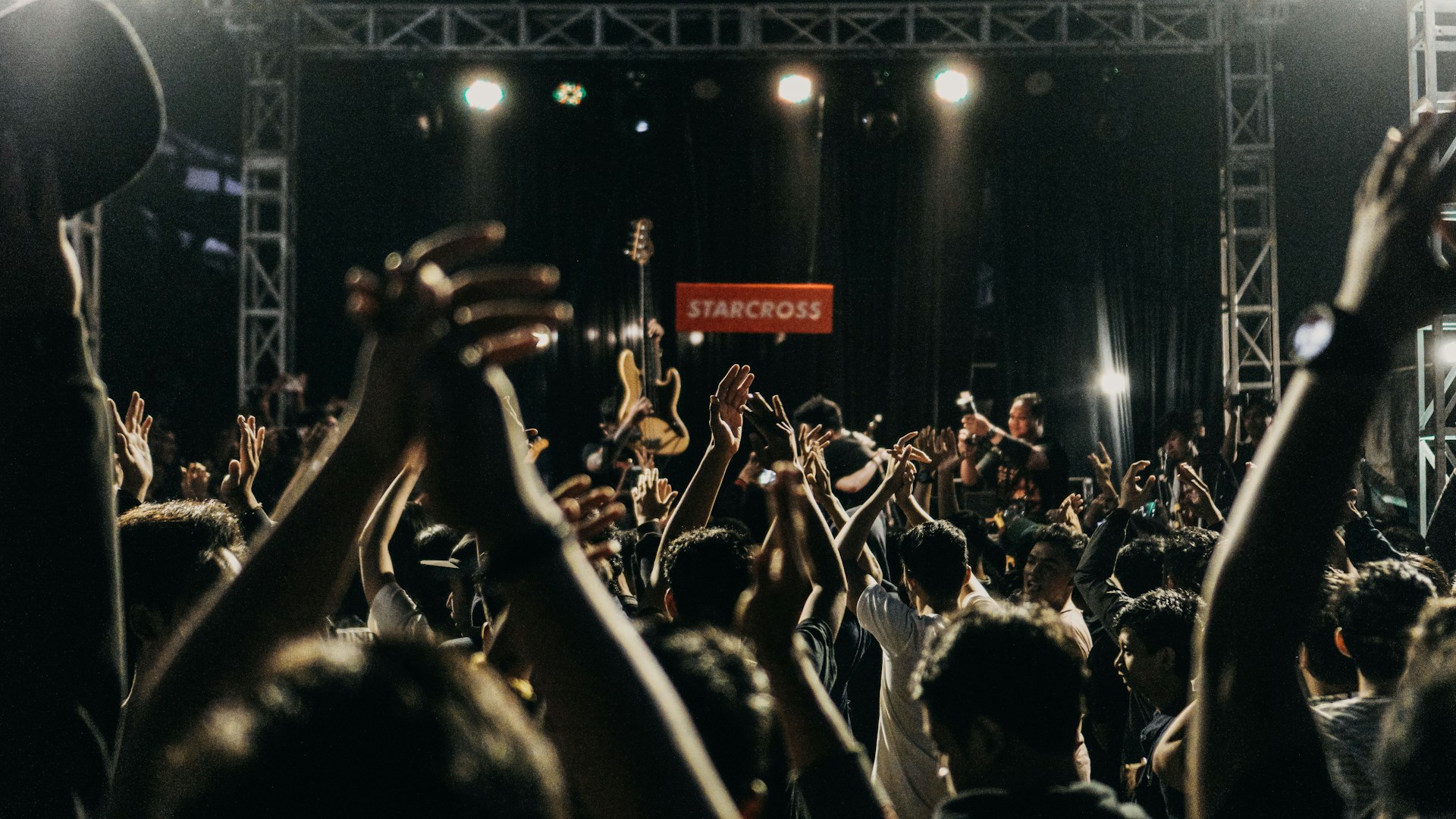 people with musical instruments performing on stage near people