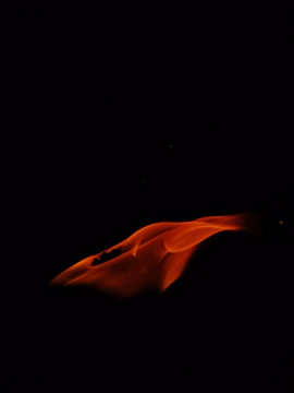 A glowing orange-yellow flame shaped like a lightbulb symbolizing bright marketing ideas.