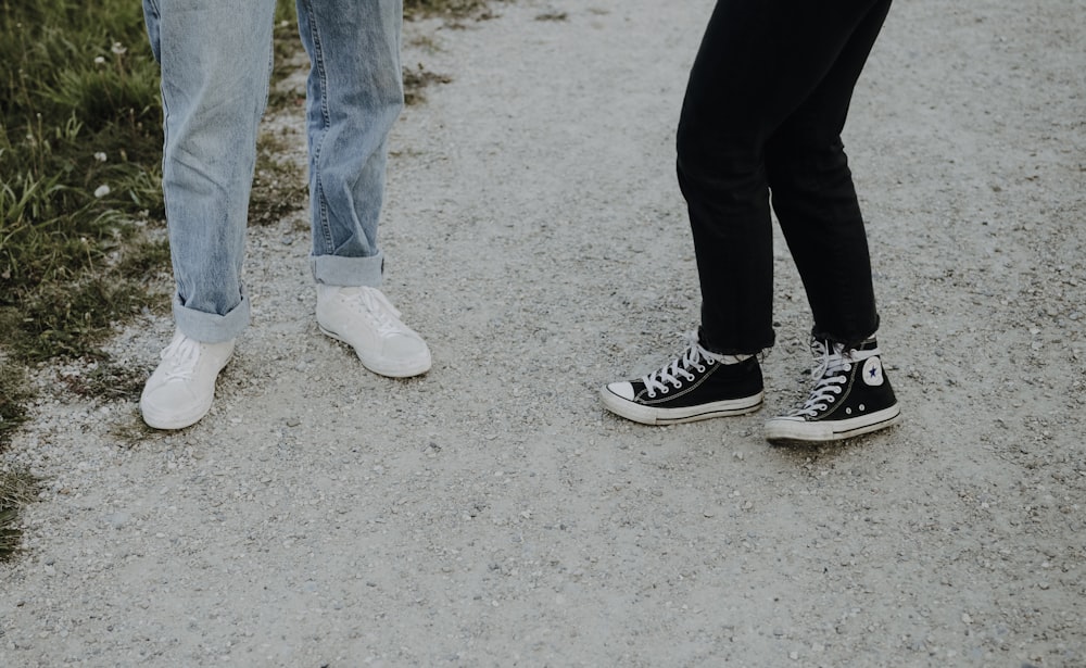 a couple of people standing on a dirt road