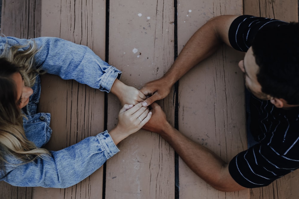 man holding woman's hands