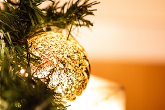 Close-up of a delicate handmade ornament shining under soft lighting.