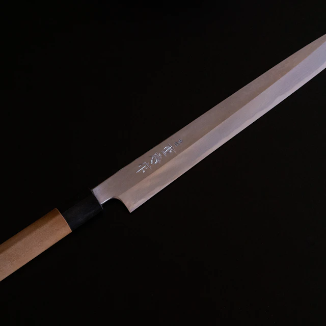 Kitchen knife with a brown wooden handle