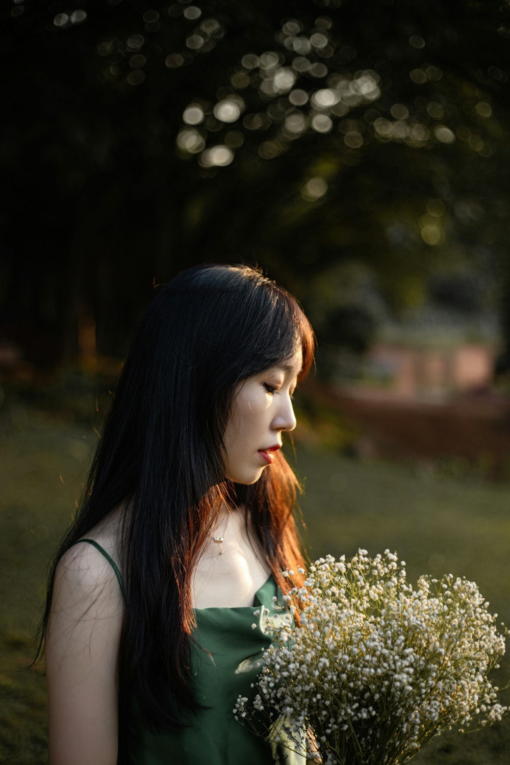 woman holding white flowers