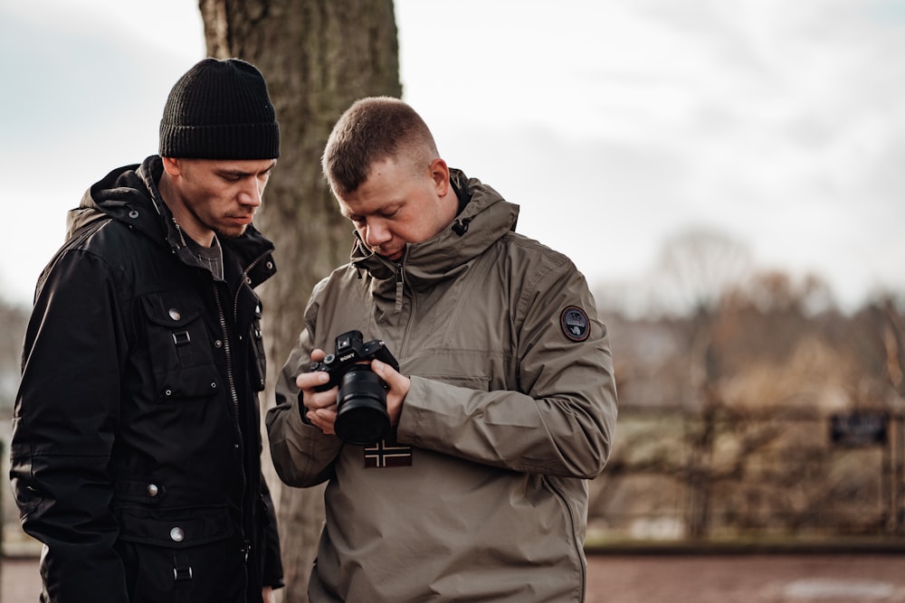 shallow focus photo of man in gray windbreaker hoodie