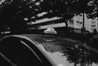 a taxi cab with a taxi sign on top of it