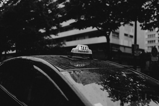 a taxi cab with a taxi sign on top of it
